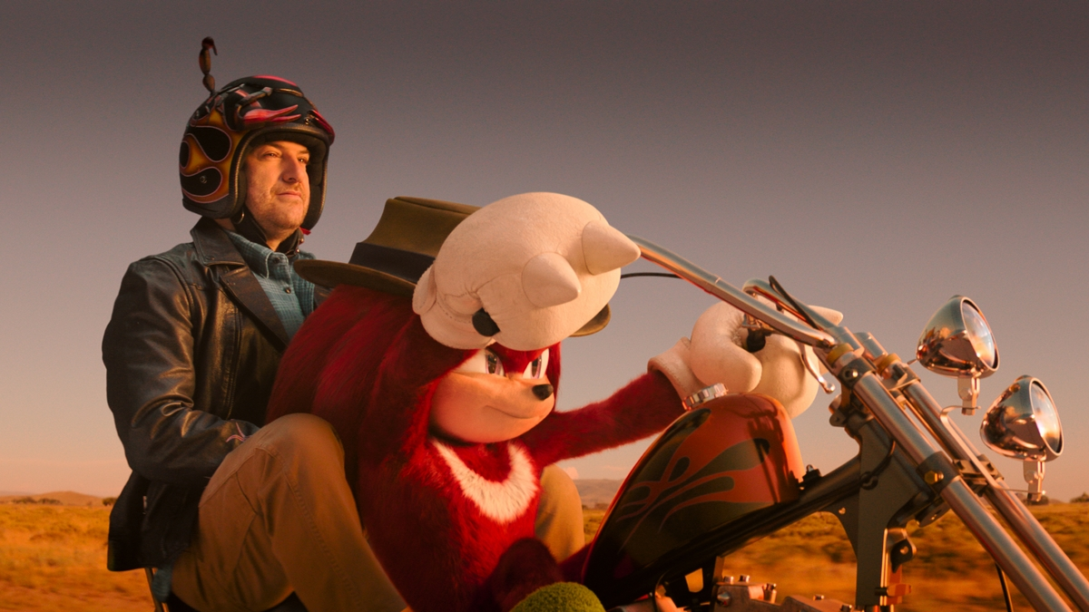 Adam Pally riding on a motorcycle with Knuckles in Paramount+'s Knuckles