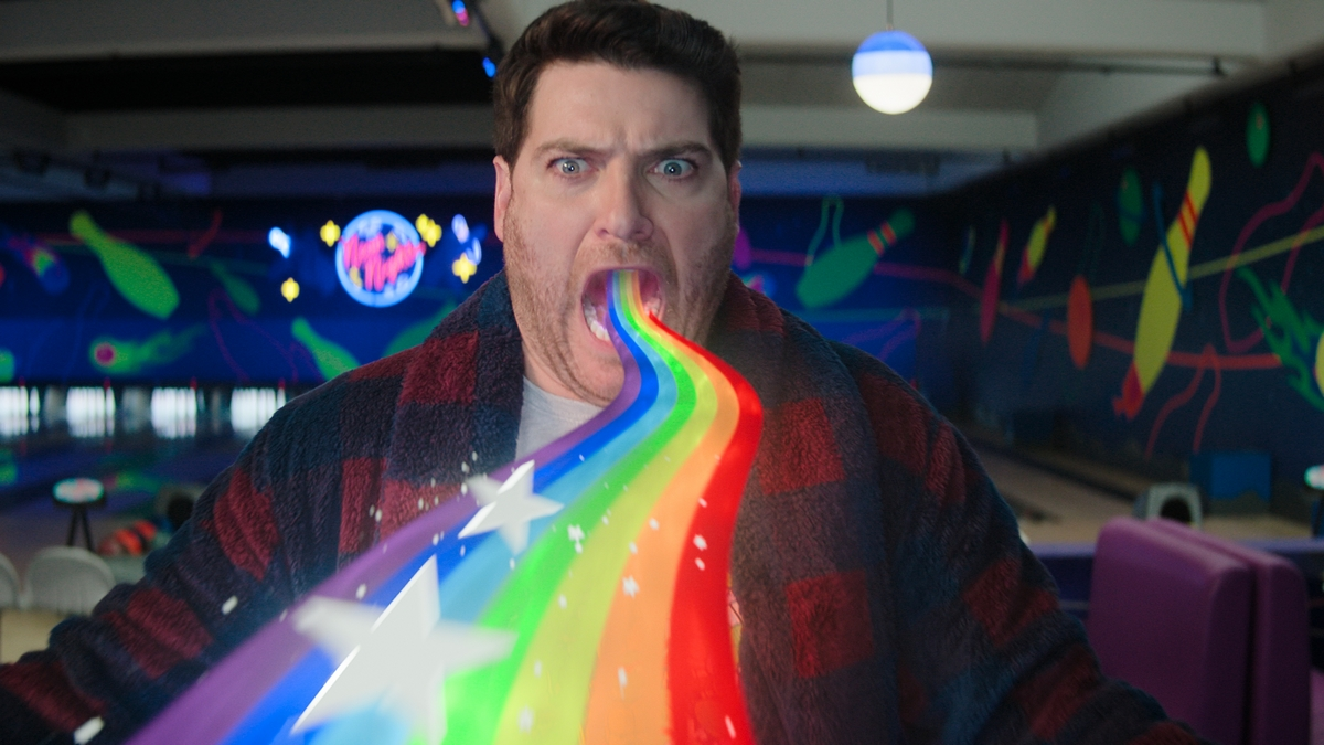 Adam Pally swallowing an animated rainbow in Paramount+'s Knuckles