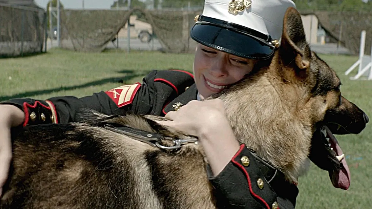 Kate Mara hugs a German Shepperd in the war film 'Megan Leavey'.
