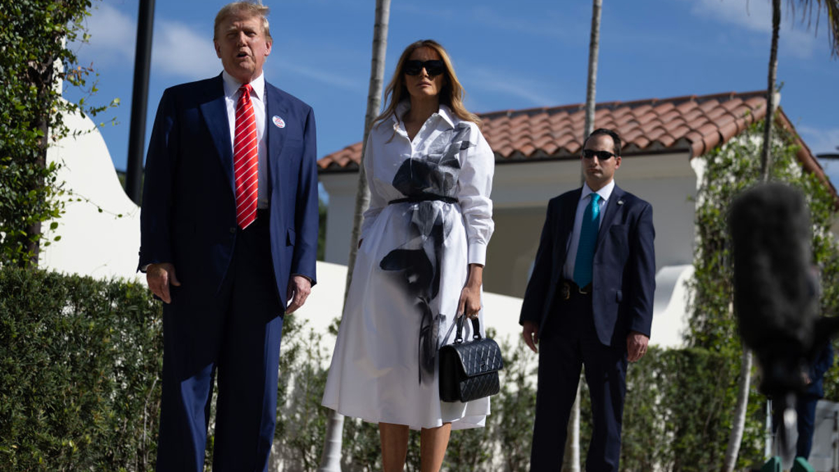 Former U.S. President Donald Trump and former first lady Melania Trump stand together as he speaks with the media after voting at a polling station setup in the Morton and Barbara Mandel Recreation Center on March 19, 2024, in Palm Beach, Florida. Trump, along with other registered Republican voters, cast ballots in the Presidential Preference Primary. There wasn't a ballot or election for Democrats since the Florida Democratic Party only provided the name of Joseph R. Biden Jr.