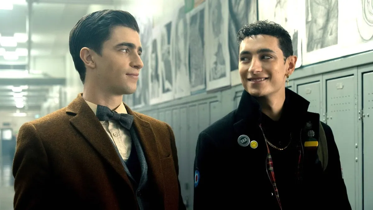 Edwin (George Rexstrew) and Charles (Jayden Revri) smiling at each other in Netflix's Dead Boy Detectives.