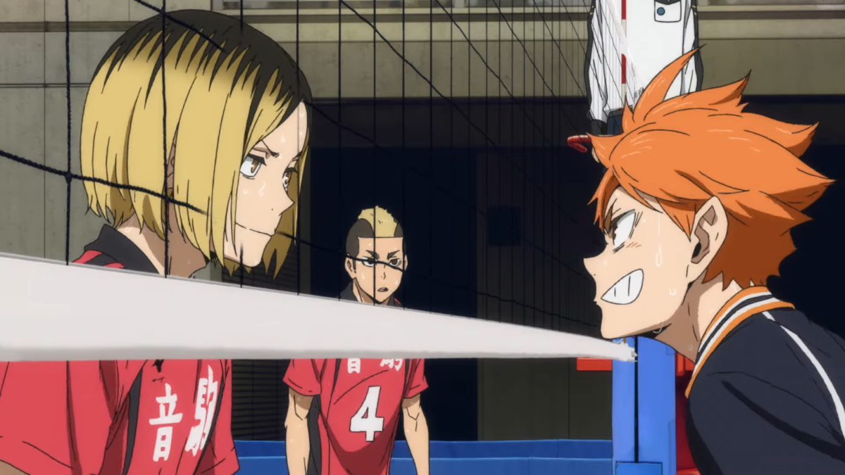 Kenma and Hinata looking at each other through the net during a volleyball match in Haikyuu!!
