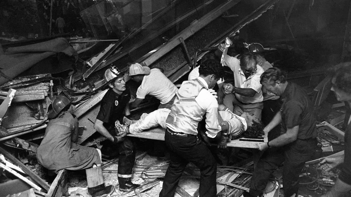 Firefighters rescue people from under a collapsed walkway in the lobby of the Hyatt Regency hotel.