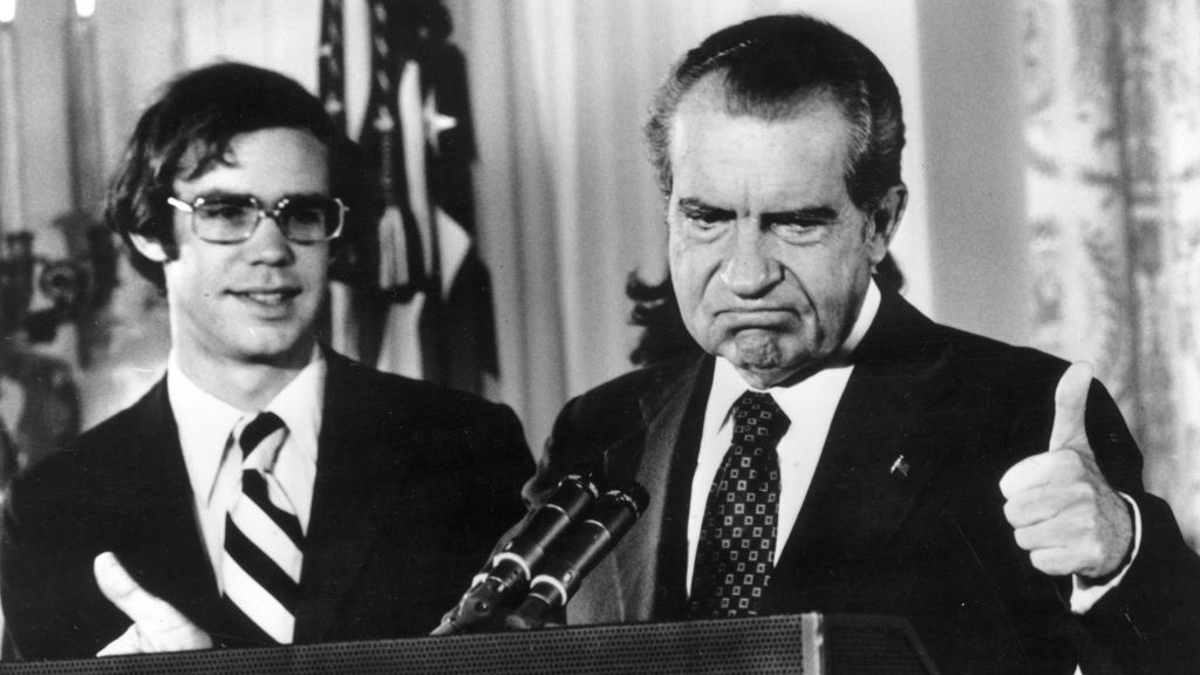 Richard Nixon (1913 - 1994) gives the thumbs up after his resignation as 37th President of the United States. His son-in-law David Eisenhower is with him as he says goodbye to his staff at the White House, Washington DC. 