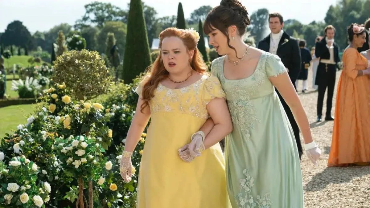 Eloise with her arm around Penelope's in season 1 of Bridgerton