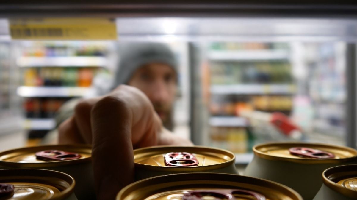 Man selecting can from fridge