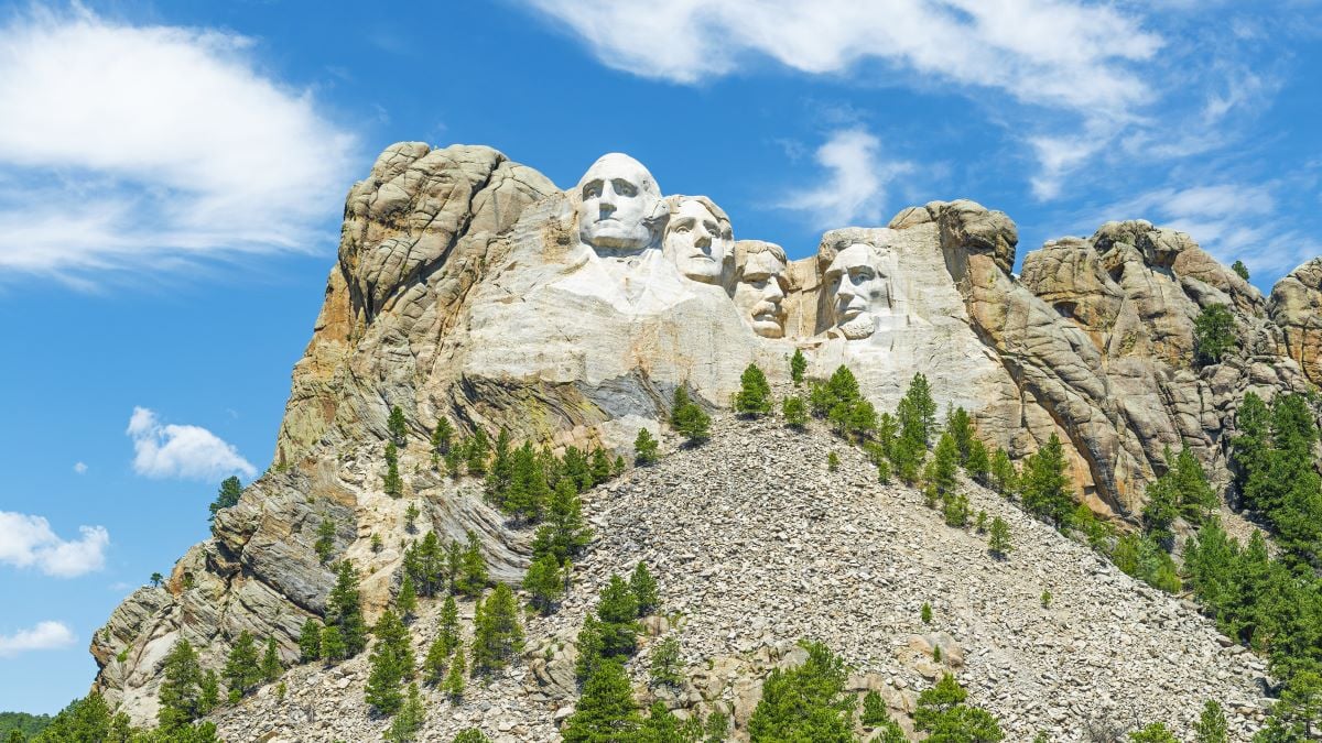 Wide angle view of Mount Rushmore national monument with the surrounding pine tree forest in the Black Hills near Rapid City in South Dakota, United States of America, USA.
