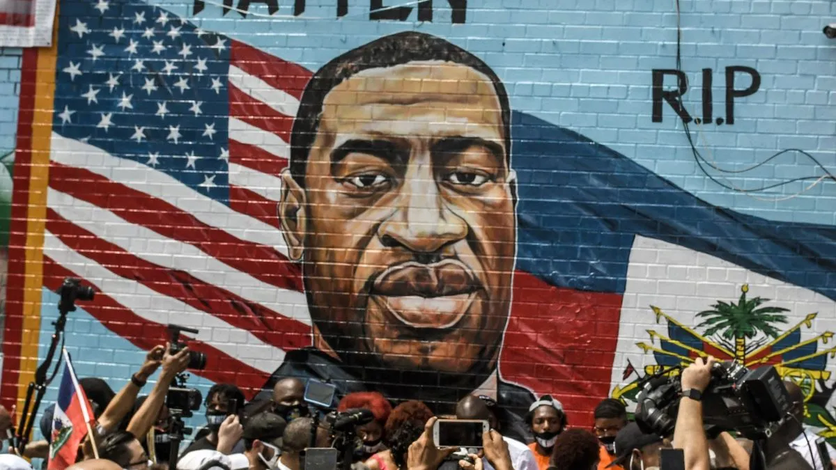 A mural painted by artist Kenny Altidor depicting George Floyd is unveiled on a sidewall of CTown Supermarket on July 13, 2020 in the Brooklyn borough New York City. George Floyd was killed by a white police officer in Minneapolis and his death has sparked a national reckoning about race and policing in the United States. (Photo by Stephanie Keith/Getty Images)