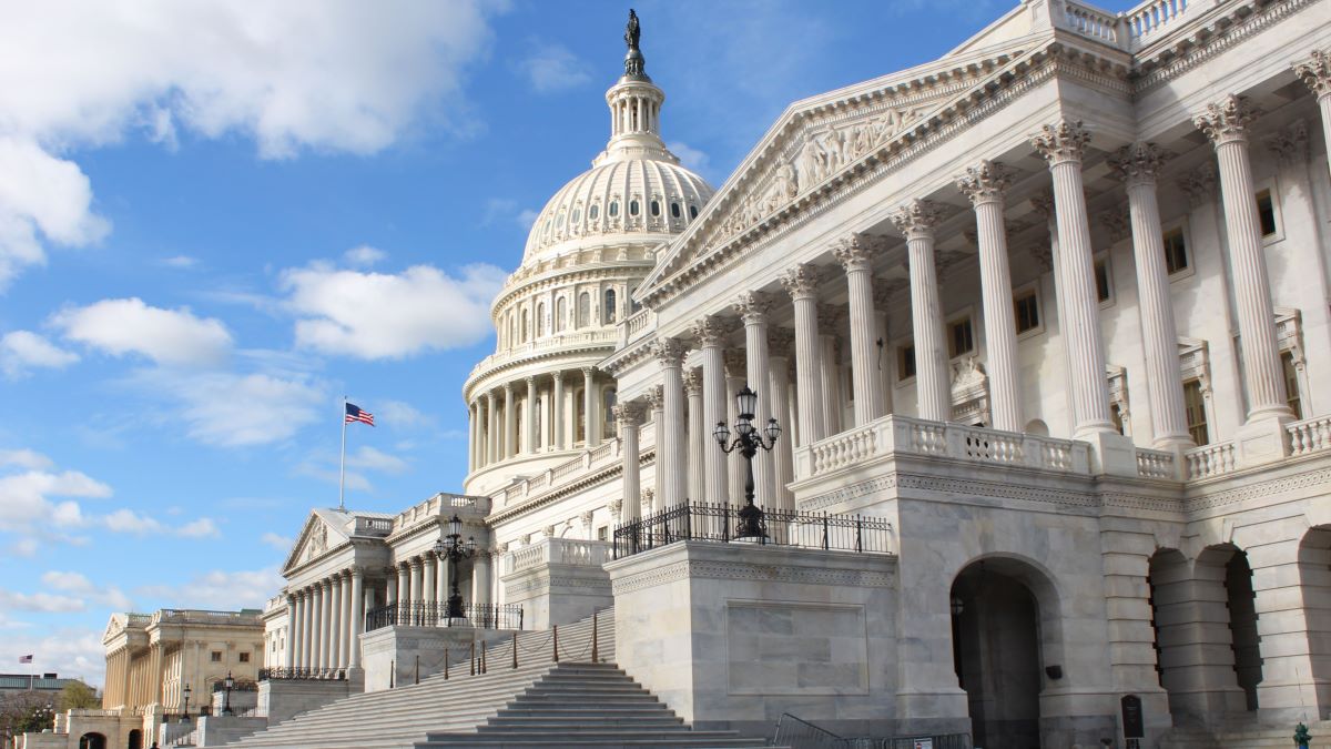 The United States Capitol building in Washington, DC, situated against a clear blue sky