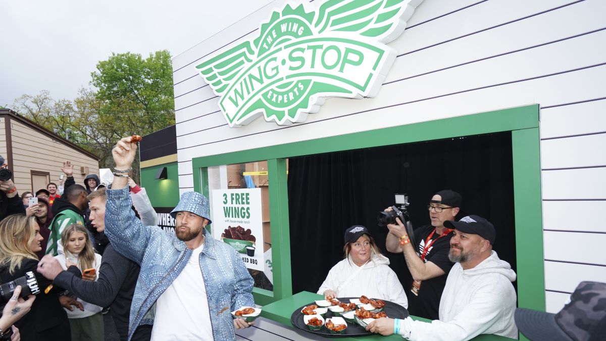 Travis Kelce #52 of the Kansas City Chiefs samples wings at a Wingstop food stand during Kelce Jam at Azura Amphitheater on April 28, 2023 in Bonner Springs, Kansas. (Photo by Kyle Rivas/Getty Images)