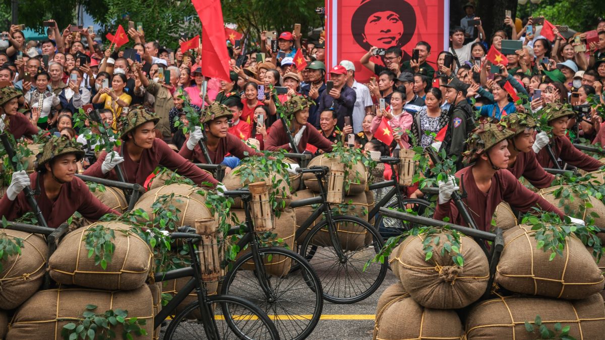 Men dressed as frontline workers dating from the First Indochina War parade by a poster of the late Vietnam's general Vo Nguyen Giap as Vietnam marks the 70th anniversary of the 1954 Dien Bien Phu battle on May 7, 2024 in Dien Bien Phu City, Dien Bien Province, Vietnam. More than 12,000 participants are set to take part in the 70th-anniversary ceremony of the Dien Bien Phu battle, a significant event in the First Indochina War, which will culminate in a grand parade on May 7 at Dien Bien Province's stadium, featuring the air force, fireworks force, and parade force. The Battle of Dien Bien Phu was one of the most major confrontations in the First Indochina War, fought between the Viet Minh Communist Revolutionaries and the French Union's French Far East Expeditionary Corps. Lasting from March 13 to May 7, 1954, this decisive battle ended with a victory for the Vietnamese side, effectively terminating the French presence in Indochina and leading to the signing of the Geneva Accords. (Photo by Linh Pham/Getty Images)