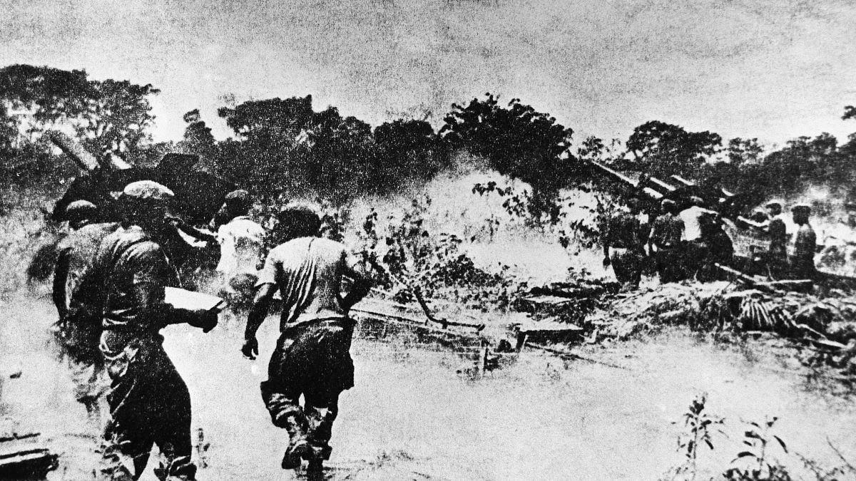 In this photograph taken from the newspaper "Revolusion," large artillery pieces are shown firing on Cuban rebels as they invade a beachhead in Cuba. It was reported that many Cuban rebels were taken prisoners in the ill-fated invasion.