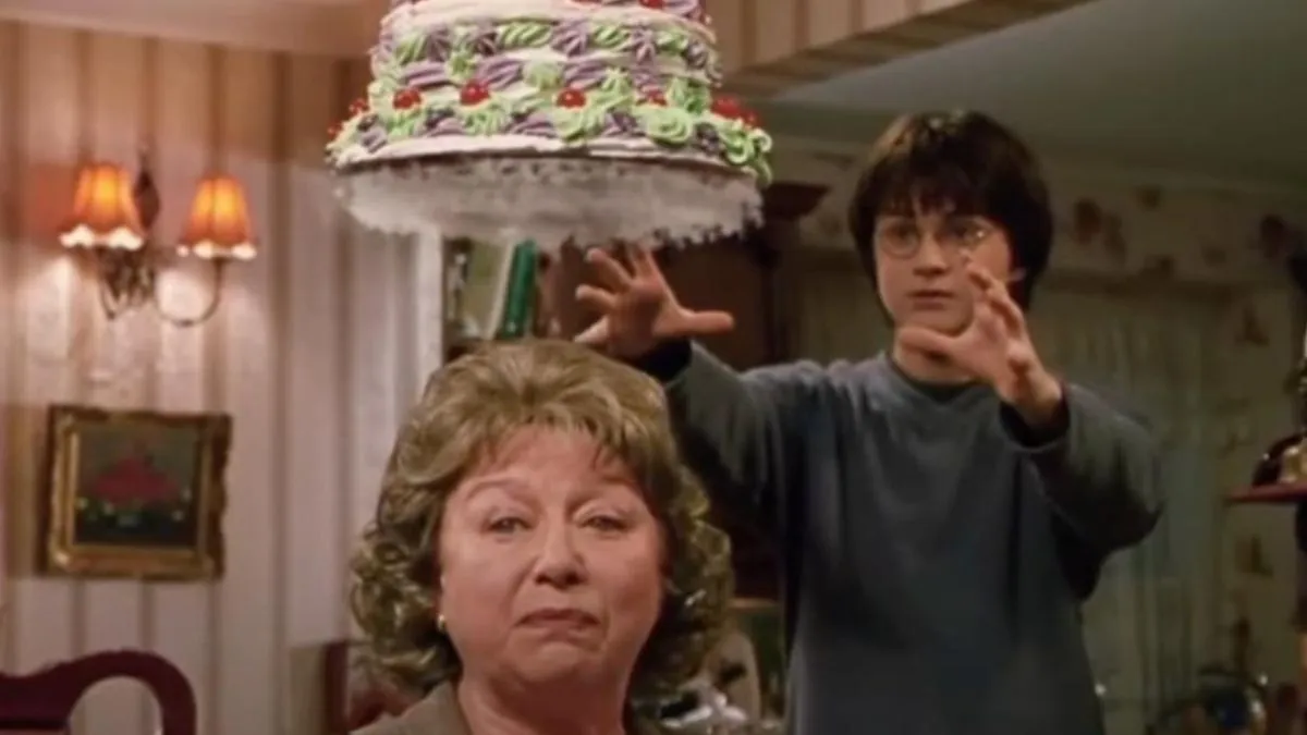 Harry Potter trying to grab a cake in Harry Potter and the Chamber of Secrets