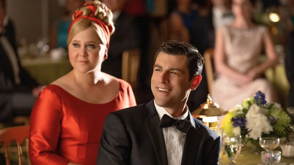 UNFROSTED. (L to R) Amy Schumer as Marjorie Post and Max Greenfield as Rick Ludwin in Unfrosted. Cr. John P. Johnson / Netflix © 2024.