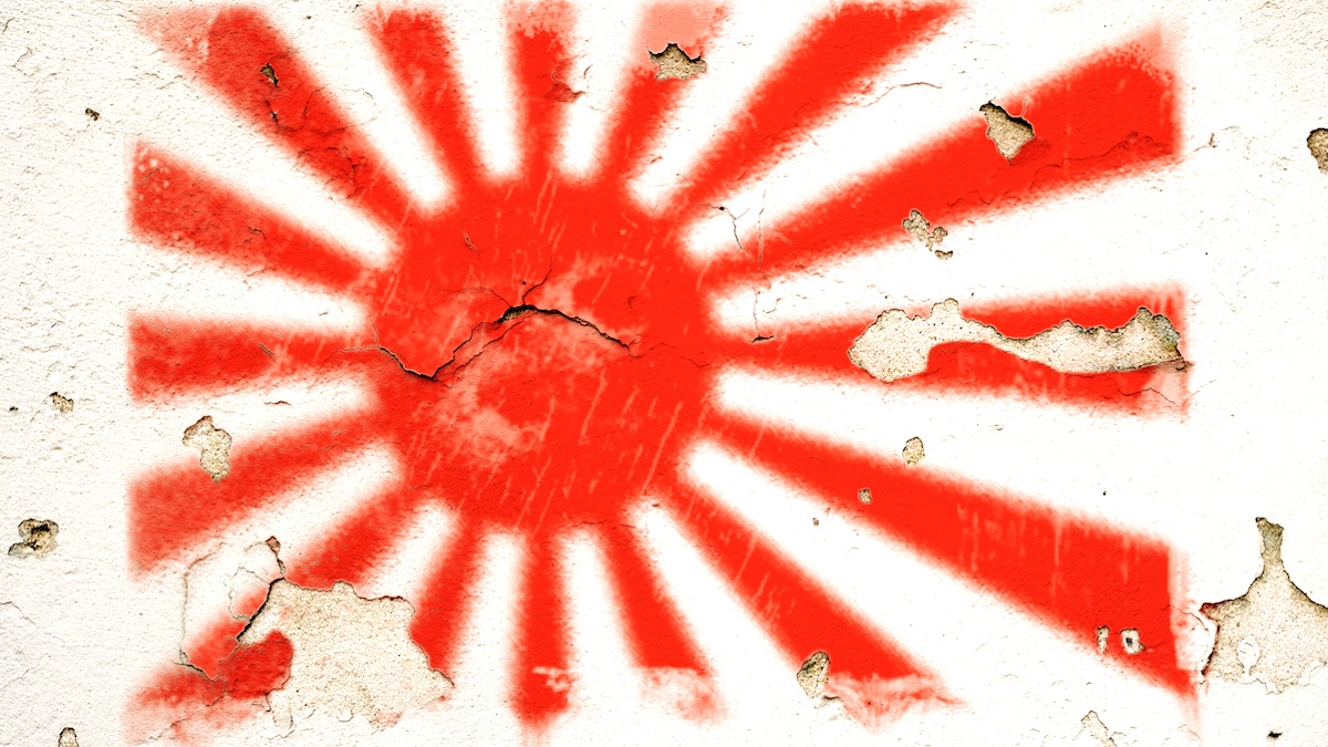 The world war two flag of Japan painted on a cracked and peeling wall.
