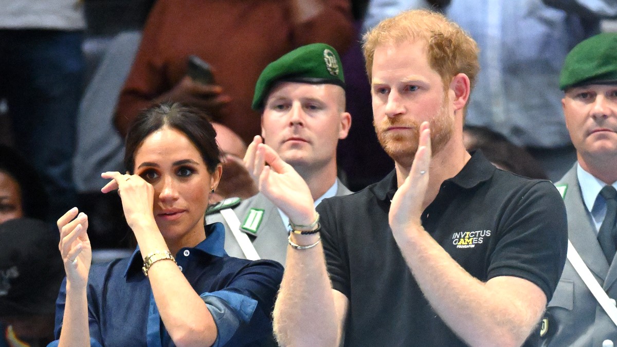 DUSSELDORF, GERMANY - SEPTEMBER 15: Prince Harry, Duke of Sussex with Meghan, Duchess of Sussex, as she wipes away a tear at the sitting volleyball medal ceremony during day six of the Invictus Games Düsseldorf 2023 on September 15, 2023 in Dusseldorf, Germany.