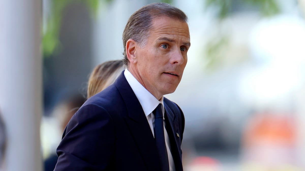 Close up photo of Hunter Biden in a black and white suit looking off-camera