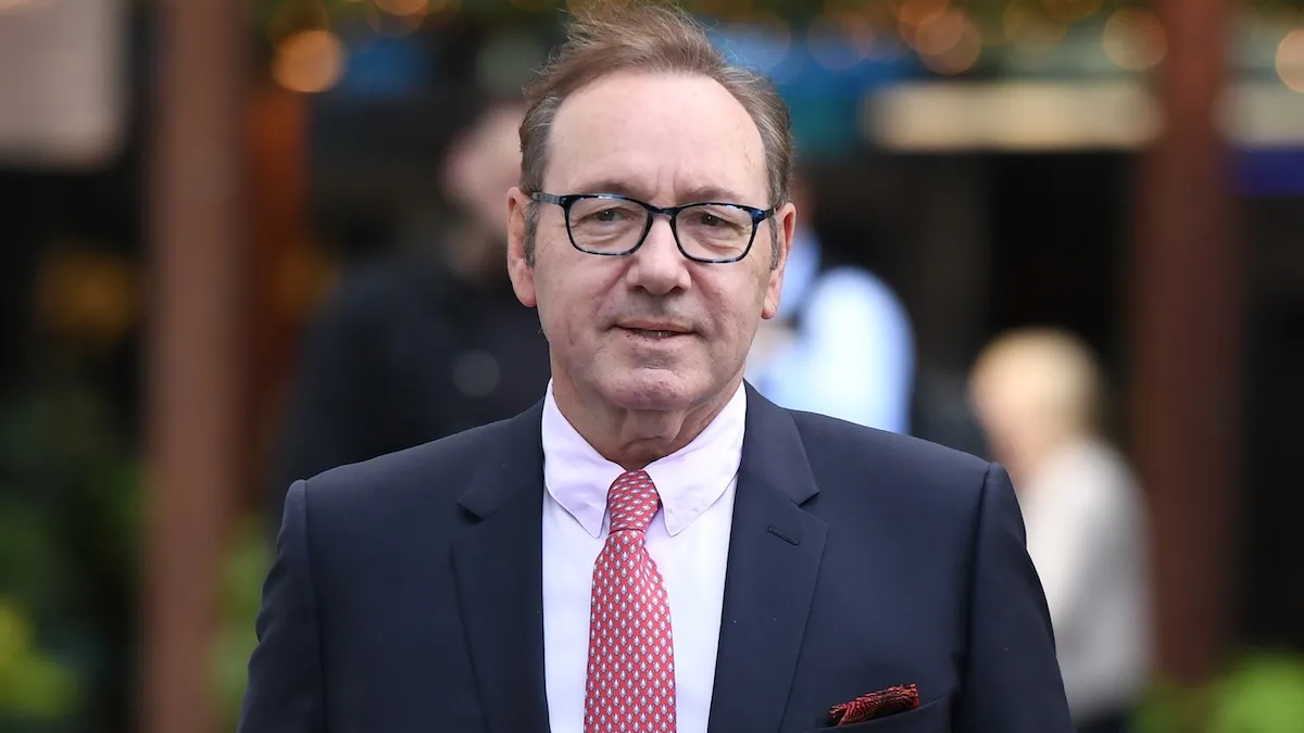 Kevin Spacey arrives in a blue and white suit at Southwark Crown Court