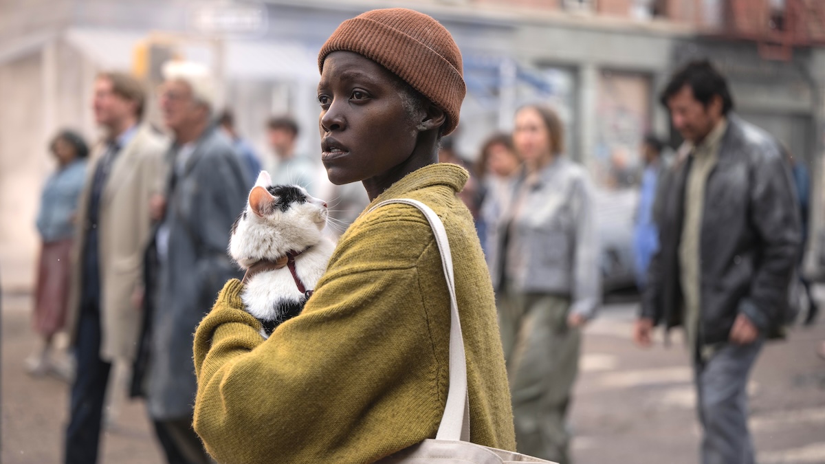 Lupita Nyong'o holding a cat in 'A Quiet Place Day One'