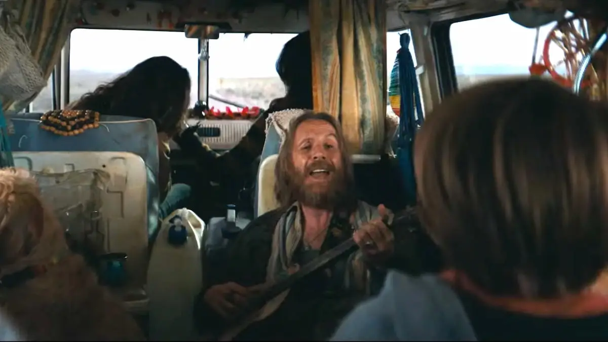 Rhys Ifans playing guitar and singing in Venom: The Last Dance.