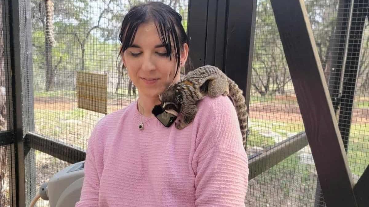 Ava Kris Tyson holding an animal on her shoulder.