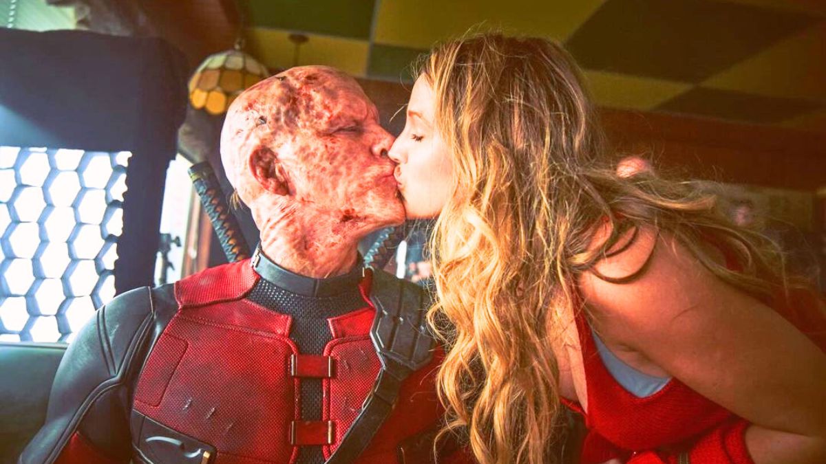 Blake Lively kissing Ryan Reynolds while wearing his Deadpool costume
