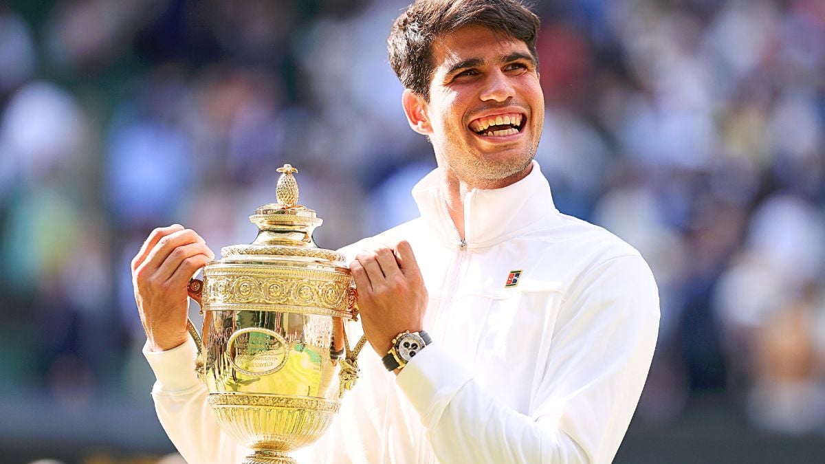 Carlos Alcaraz of Spain celebrates with the trophy after defeating Novak Djokovic of Serbia in the Gentlemen's Singles Final during day fourteen of The Championships Wimbledon 2024 at All England Lawn Tennis and Croquet Club on July 14, 2024 in London, England.