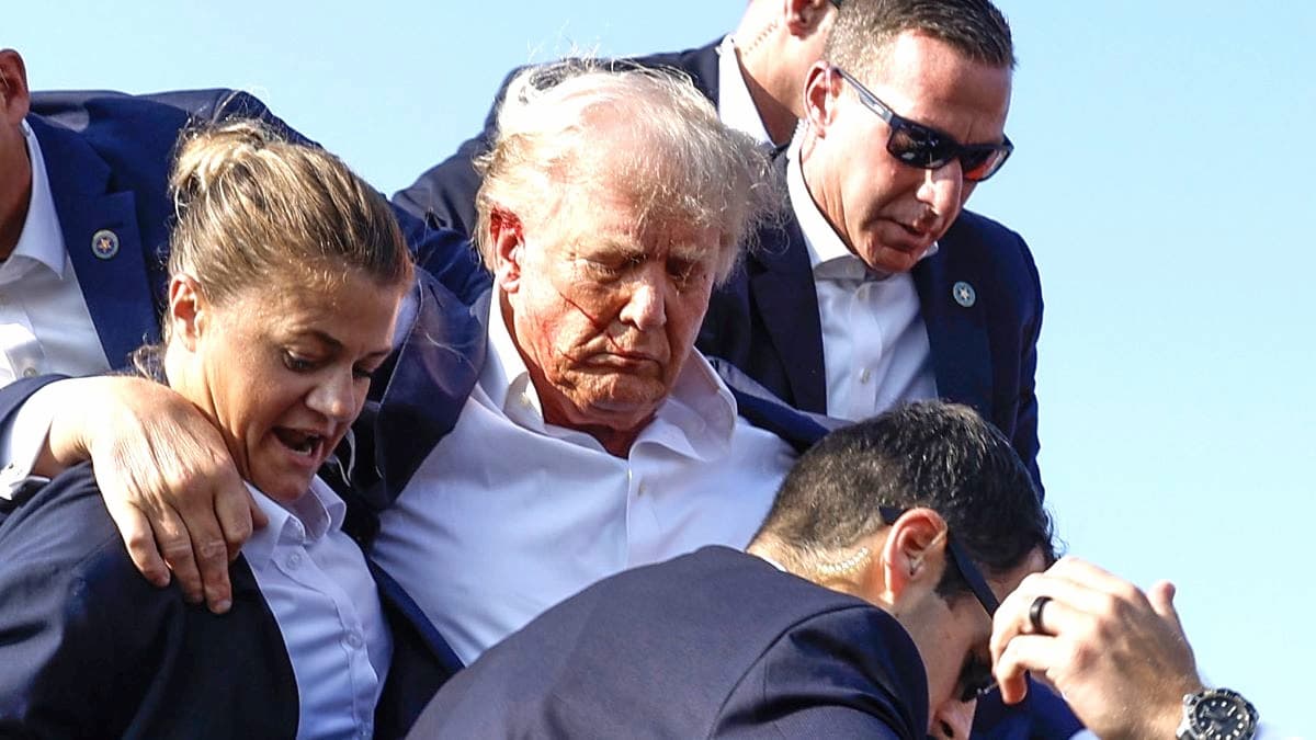 Republican presidential candidate former President Donald Trump is rushed offstage by U.S. Secret Service agents after being grazed by a bullet during a rally on July 13, 2024 in Butler, Pennsylvania. Butler County district attorney Richard Goldinger said the shooter is dead after injuring former U.S. President Donald Trump, killing one audience member and injuring another in the shooting.