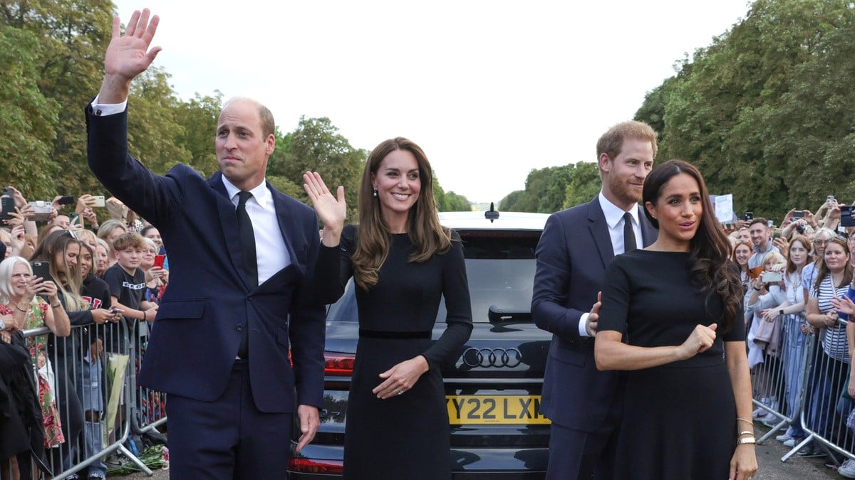 Catherine, Princess of Wales, Prince William, Prince of Wales, Prince Harry, Duke of Sussex, and Meghan, Duchess of Sussex wave to crowd on the long Walk at Windsor Castle on September 10, 2022 in Windsor, England.