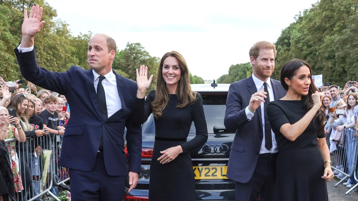 Catherine, Princess of Wales, Prince William, Prince of Wales, Prince Harry, Duke of Sussex, and Meghan, Duchess of Sussex wave to crowd on the long Walk at Windsor Castle on September 10, 2022 in Windsor, England