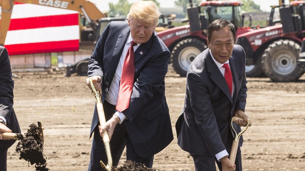U.S. President Donald Trump (C) breaks ground along with Wisconsin Gov. Scott Walker (L) and Foxconn CEO Terry Gou (R) at the groundbreaking for the Foxconn Technology Group computer screen plant on June 28, 2018 in Mt Pleasant, Wisconsin. Foxconn has committed to build a $10 billion plant in what it has named the Wisconn Valley Science and Technology Park, and to creating 13,000 Wisconsin jobs. (Photo by Andy Manis/Getty Images)