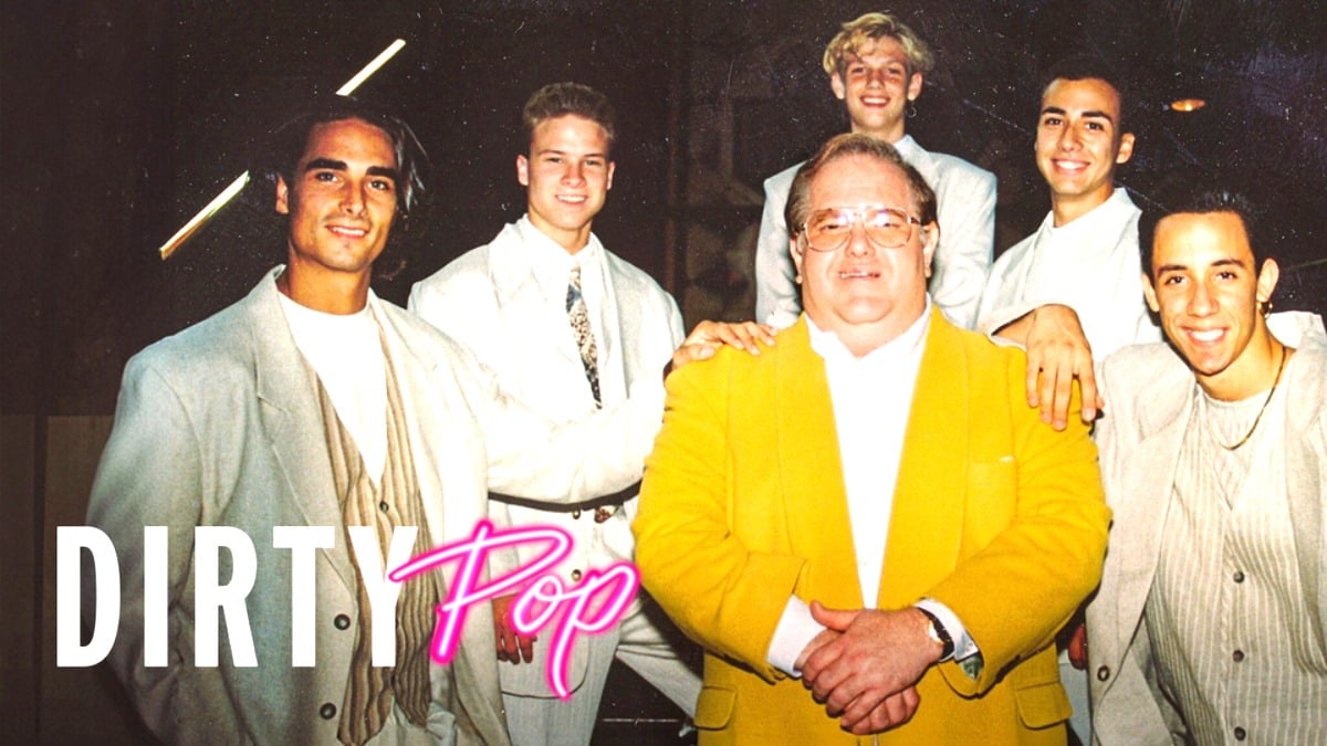 Lou Pearlman standing with the Backstreet Boys members in a promo image for Dirty Pop