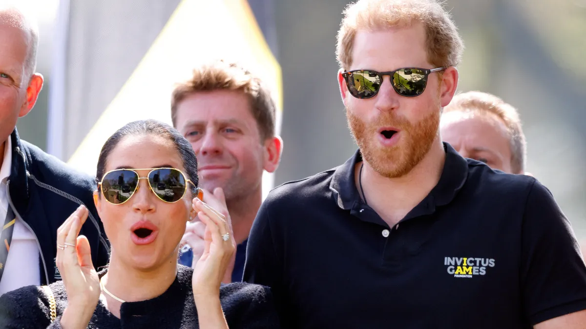 THE HAGUE, NETHERLANDS - APRIL 16: (EMBARGOED FOR PUBLICATION IN UK NEWSPAPERS UNTIL 24 HOURS AFTER CREATE DATE AND TIME) Meghan, Duchess of Sussex and Prince Harry, Duke of Sussex react as they watch the Land Rover Driving Challenge, on day 1 of the Invictus Games 2020 at Zuiderpark on April 16, 2022 in The Hague, Netherlands.