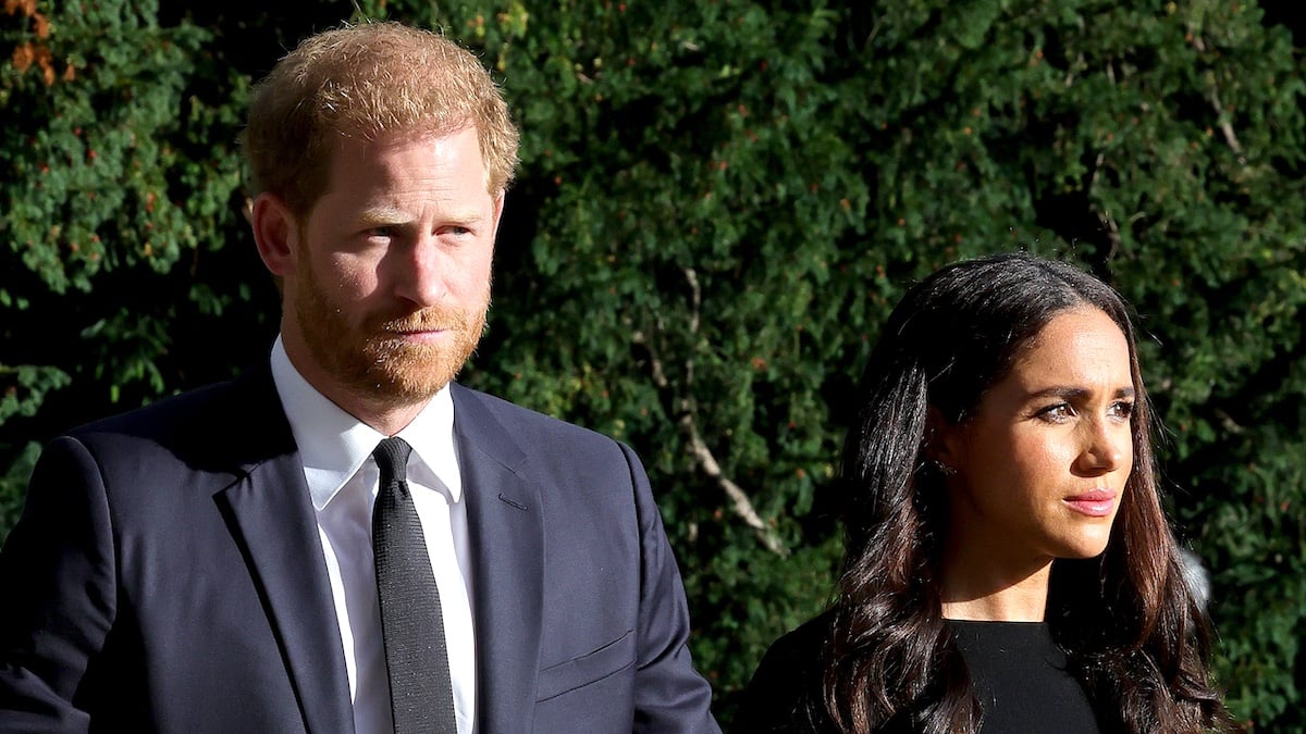 WINDSOR, ENGLAND - SEPTEMBER 10: Prince Harry, Duke of Sussex, and Meghan, Duchess of Sussex on the long Walk at Windsor Castle arrive to view flowers and tributes to HM Queen Elizabeth on September 10, 2022 in Windsor, England. Crowds have gathered and tributes left at the gates of Windsor Castle to Queen Elizabeth II, who died at Balmoral Castle on 8 September, 2022.