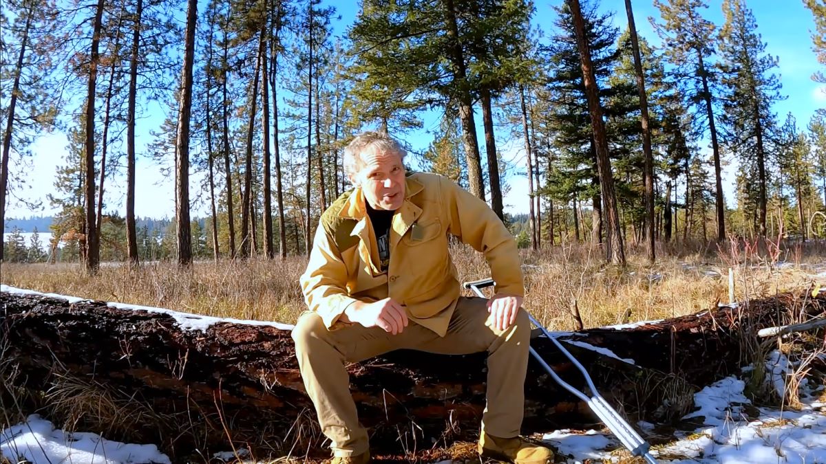 A screengrab of Paul Harrell's "I'm Dead" YouTube video, showing Harrell sitting in a forest.