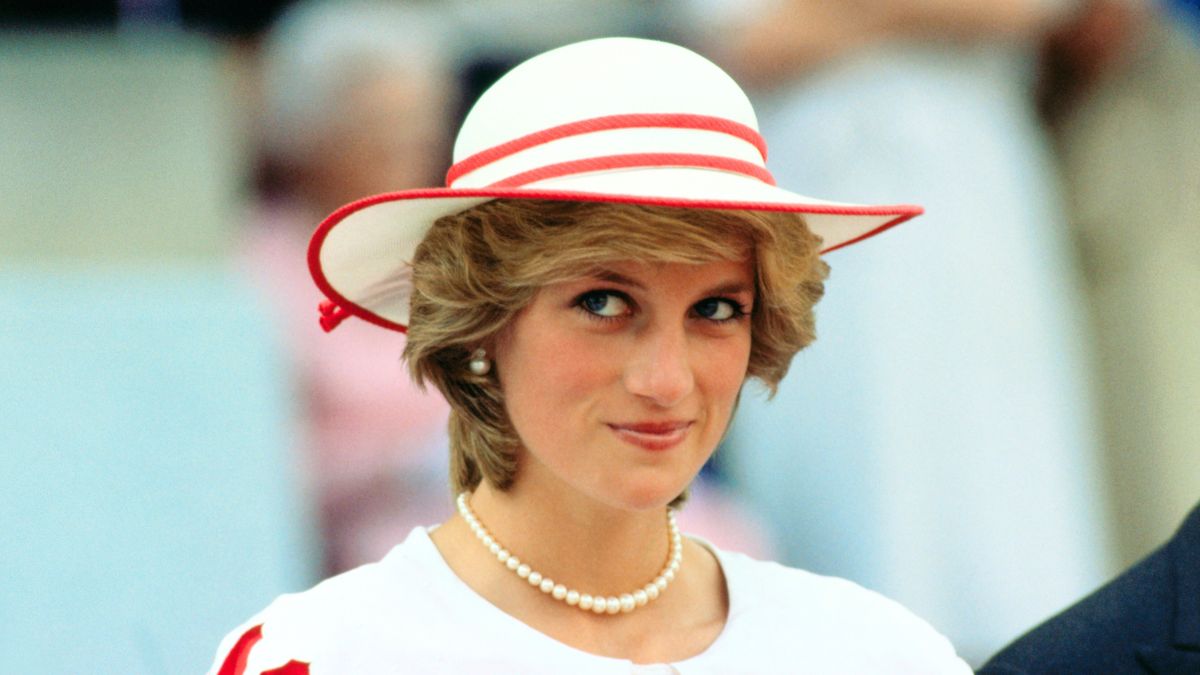 Diana, Princess of Wales, wears an outfit in the colors of Canada during a state visit to Edmonton, Alberta, with her husband.