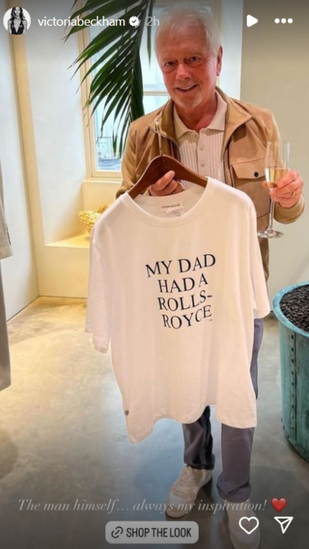 Victoria Beckham's dad Anthony holding a T-shirt with the Rolls-Royce slogan