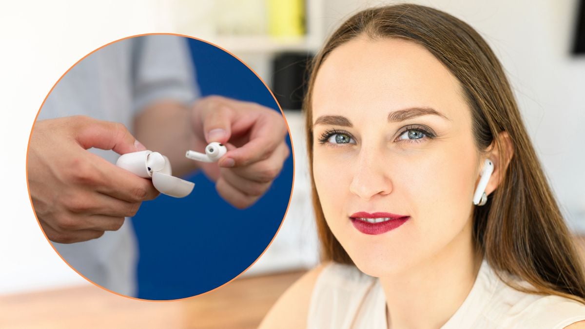 Home office. Close up portrait of a young attractive woman with airpods headphones, she looks at camera and smiles person holding a wireless earbuds case, ready to listen to music