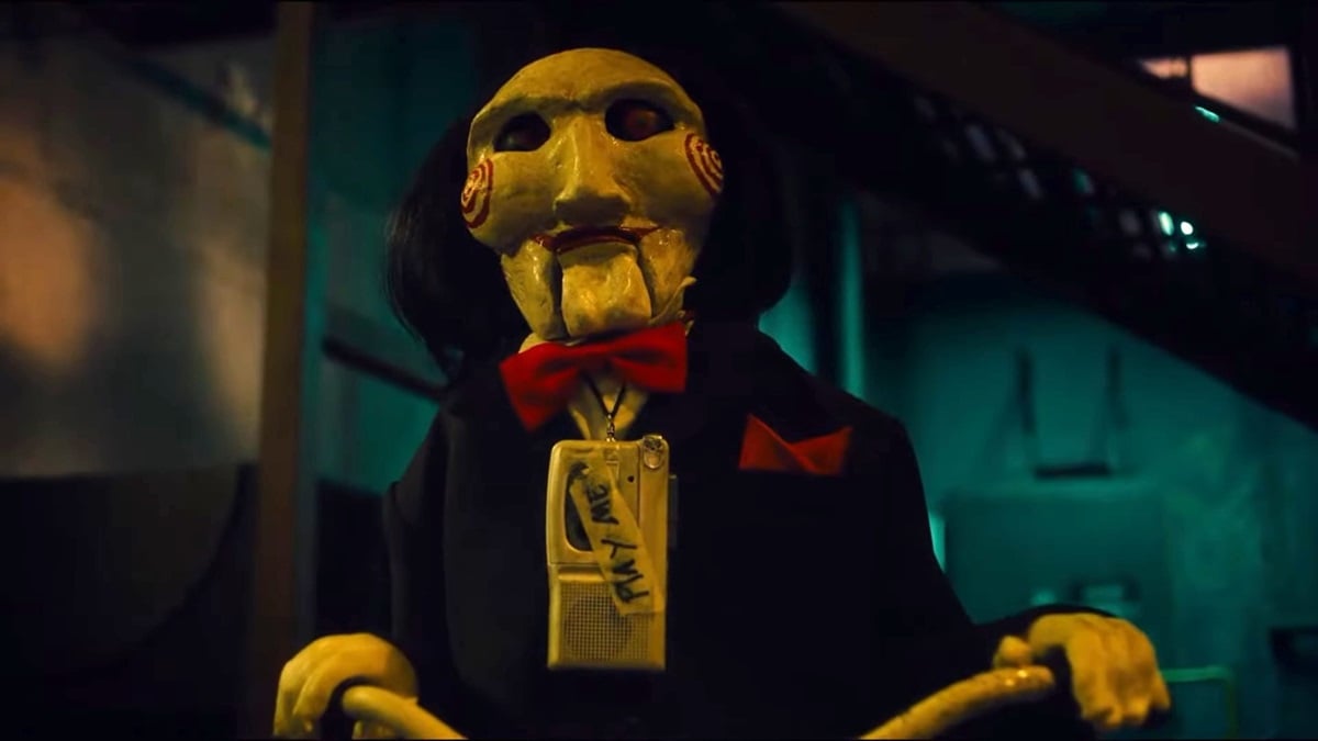 Billy the Puppet wearing a tape around his neck in Saw X