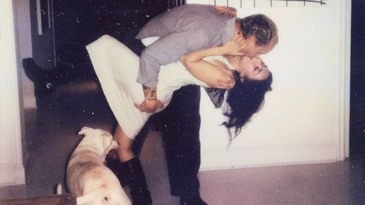 George Daniel and Charli XCX share a passionate kiss.