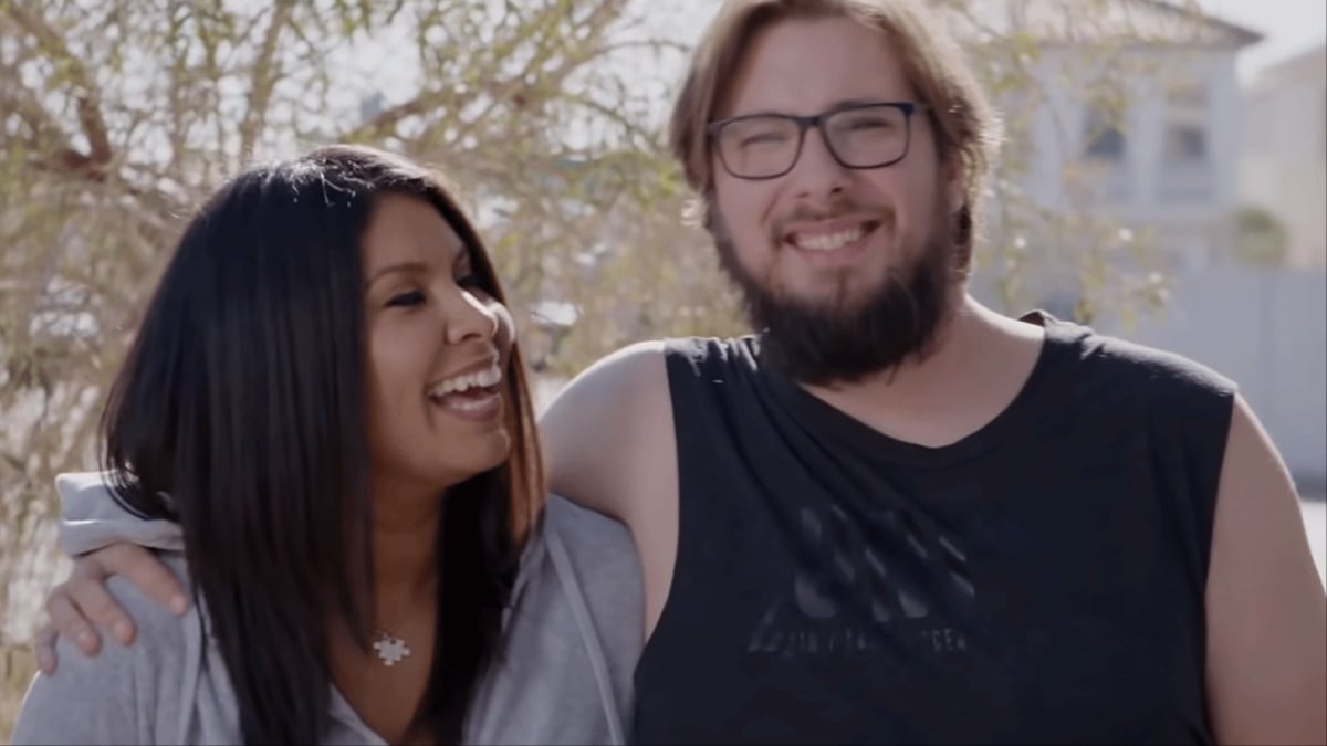 Colt with his arm around Vanessa, both smiling