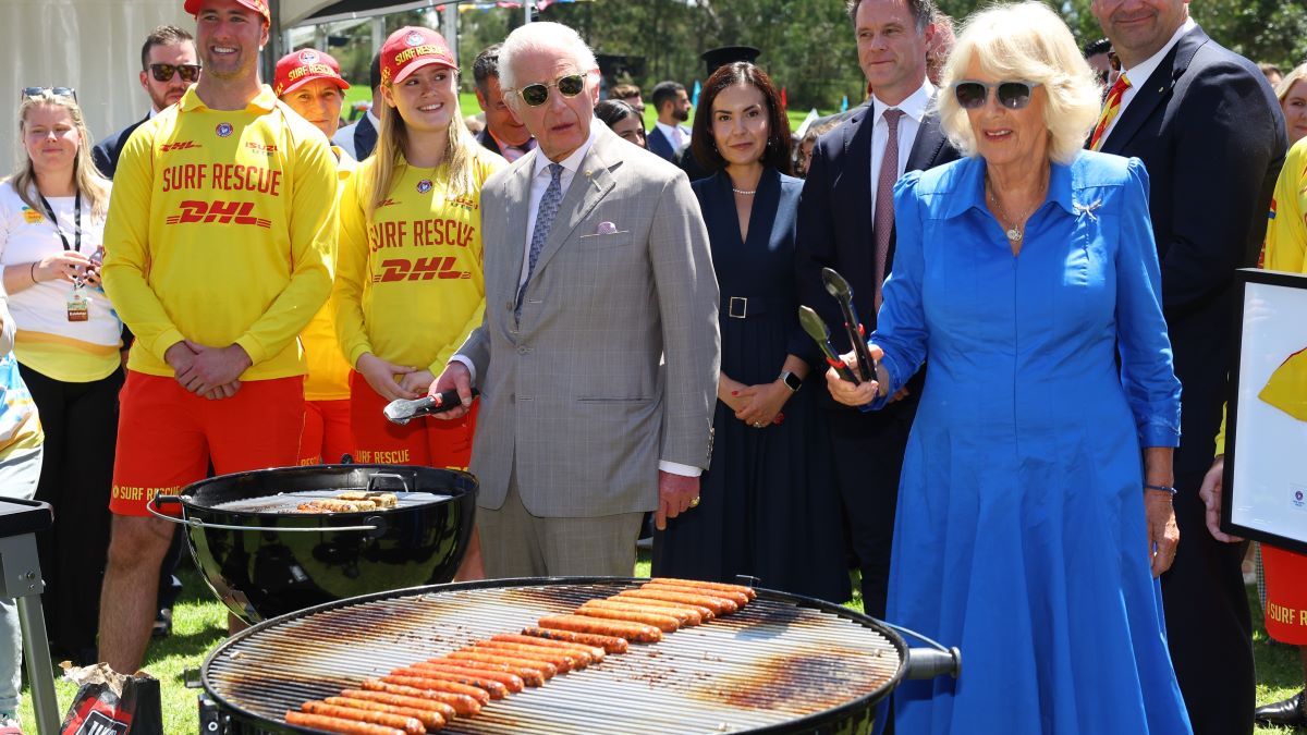 King Charles III and Queen Camilla cook sausages for the food stalls at the Premier's Community Barbeque at Parramatta Park on October 22, 2024 in Sydney, Australia. The King's visit to Australia is his first as monarch, and the Commonwealth Heads of Government Meeting (CHOGM) in Samoa will be his first as head of the Commonwealth. (Photo by Toby Melville-Pool/Getty Images)