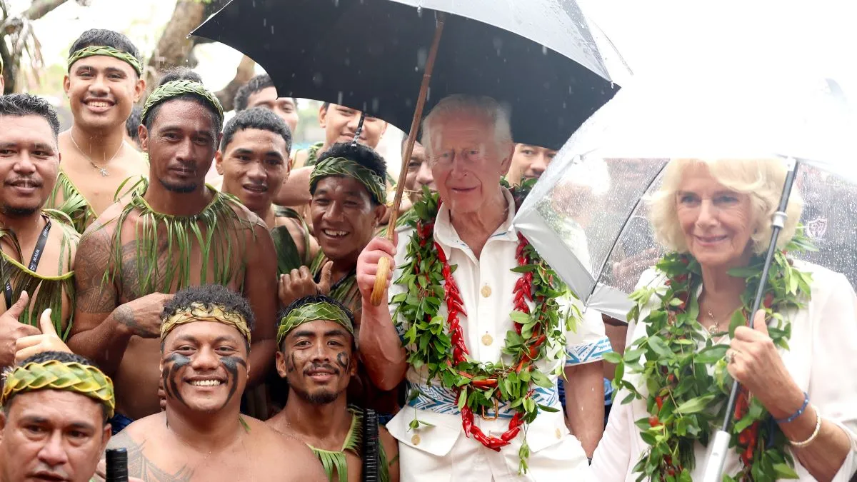 King Charles III and Queen Camilla pose with a local traditional cricket team members during his Samoa Cultural Village visit on October 24, 2024 in Apia, Samoa. The King's visit to Australia is his first as monarch, and the Commonwealth Heads of Government Meeting (CHOGM) in Samoa will be his first as head of the Commonwealth. (Photo by Chris Jackson/Getty Images)