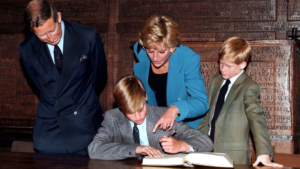 Prince William follows Eton tradition by signing a book before starting at the school, as Prince Charles, Princess Diana (1961 - 1997) and Prince Harry look on, 6th September 1995. (Photo by Jayne Fincher/Getty Images)