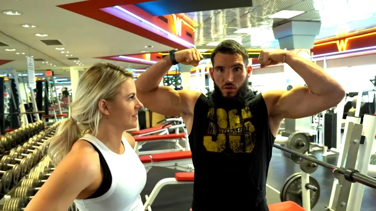 Candice LeRae watching Johnny Gargano flex