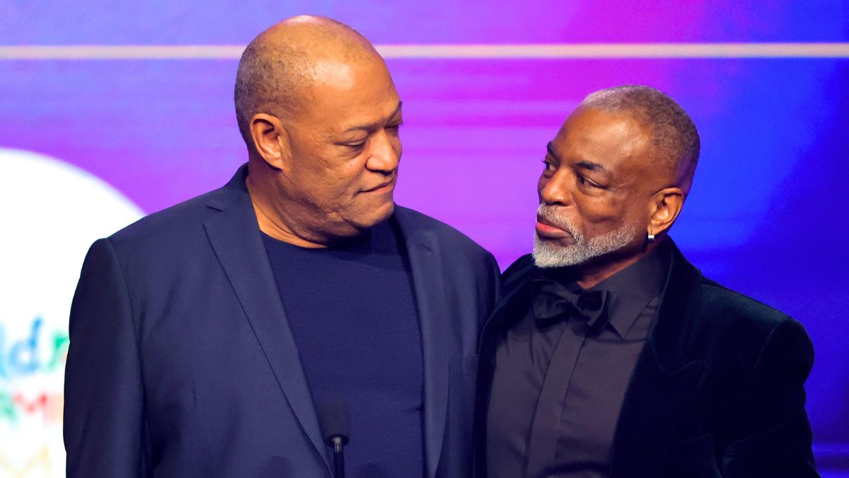 LeVar Burton (R) accepts the Lifetime Achievement Award from Laurence Fishburne onstage during the 2022 Children's & Family Emmys