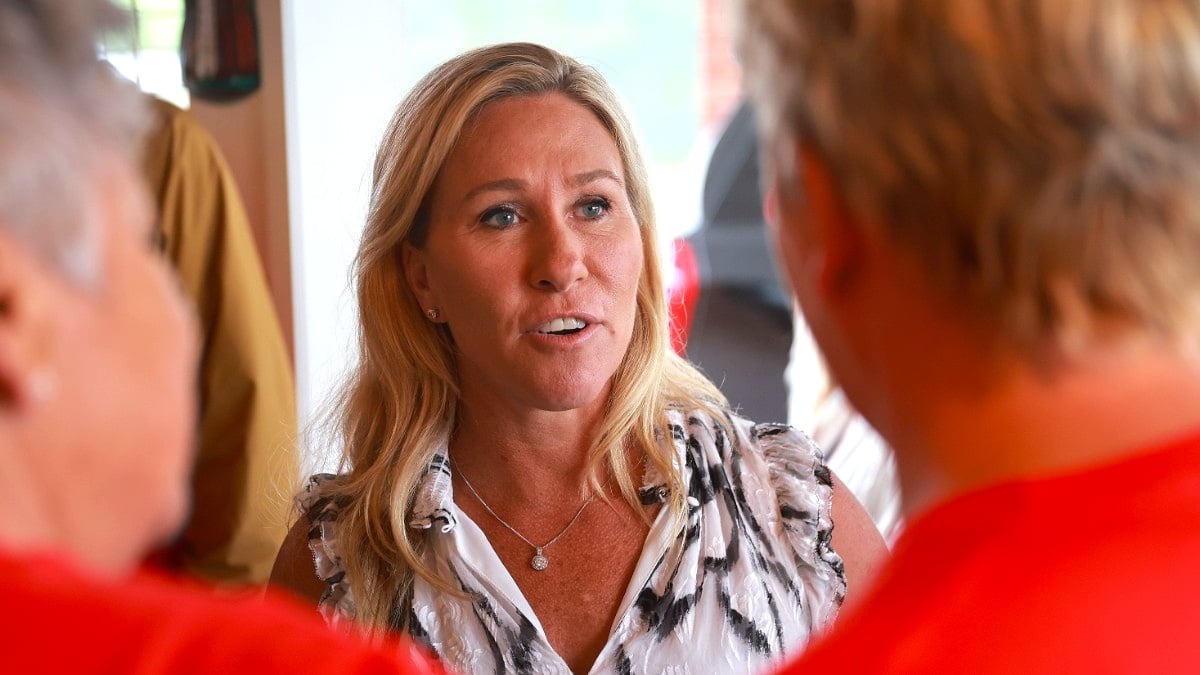 Marjorie Taylor Greene (R-GA) interacts with voters during a campaign stop at the Creme Hut