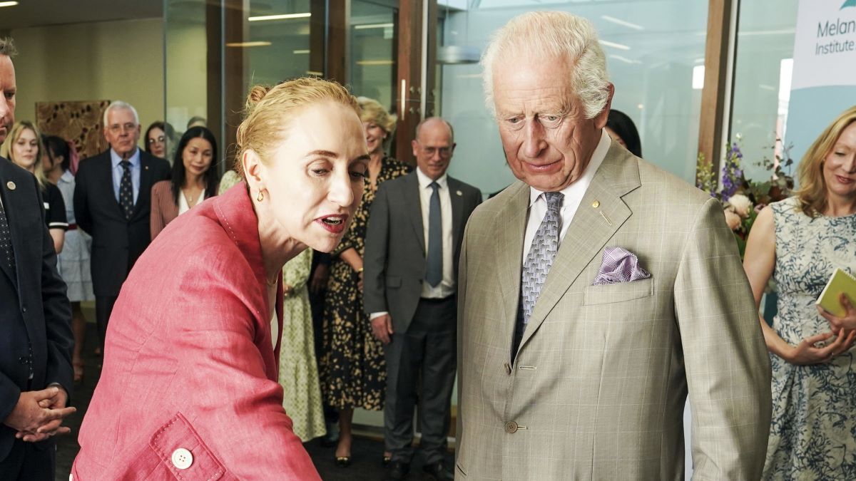 King Charles III (R) is briefed by co-medical director Georgina Long during a visit to the Melanoma Institute of Australia on October 22, 2024 in Sydney, Australia. The King's visit to Australia is his first as monarch, and the Commonwealth Heads of Government Meeting (CHOGM) in Samoa will be his first as head of the Commonwealth.