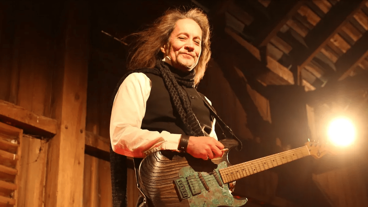 An image of guitarist Jake E. Lee performing on stage