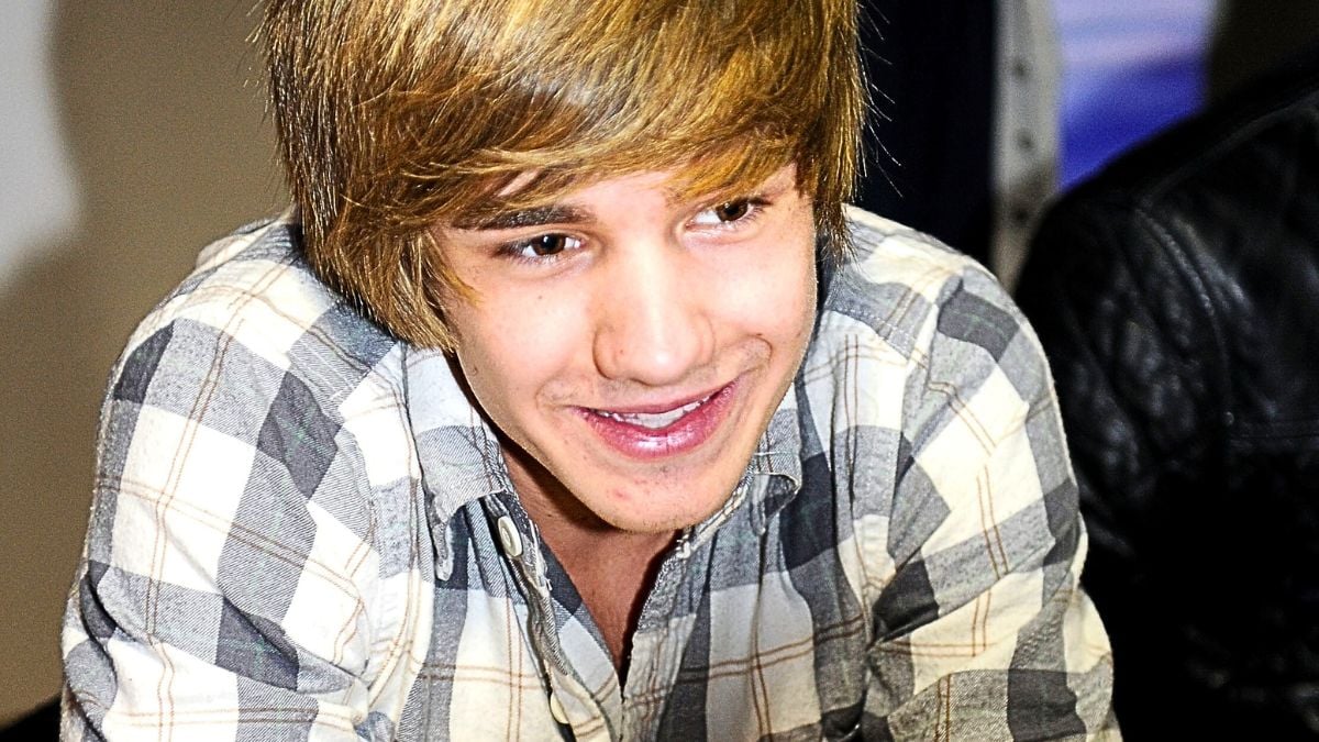  Liam Payne of one Direction signs their new book 'One Direction: Forever Young: Our Official X-Factor Story' at HMV on March 7, 2011 in Manchester, England. 